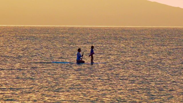 EL SARGENTO LA VENTANA MEXICO-2020: Two People Paddleboarding on Calm Ocean at Sunset