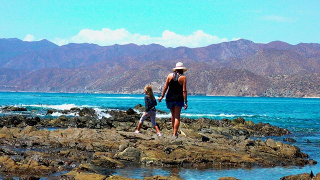 EL SARGENTO LA VENTANA MEXICO-2020: Woman and Child Holding Hands on Rocky Shore