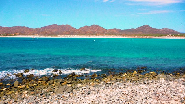 EL SARGENTO LA VENTANA MEXICO-2020: Waves Crashing on Rocky Shore with Distant Mountains