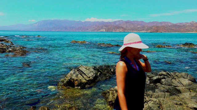 EL SARGENTO LA VENTANA MEXICO-2020: Woman Walking on Rocky Shore and Exiting Frame