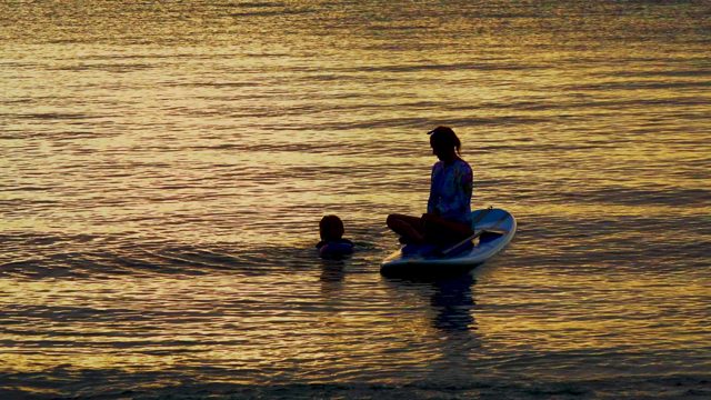 EL SARGENTO LA VENTANA MEXICO-2020: Person on Surfboard with Swimmer in Sunset Water