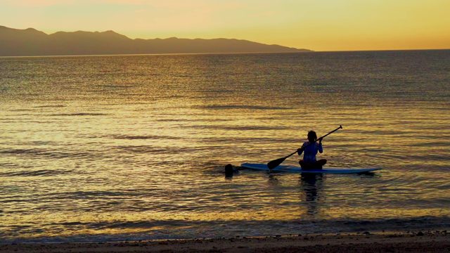 EL SARGENTO LA VENTANA MEXICO-2020: Paddleboarder and Swimmer in Calm Ocean at Sunset