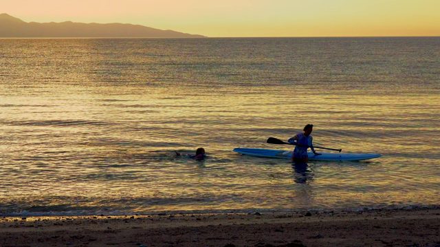 EL SARGENTO LA VENTANA MEXICO-2020: Two People in Ocean Near Beach at Sunset