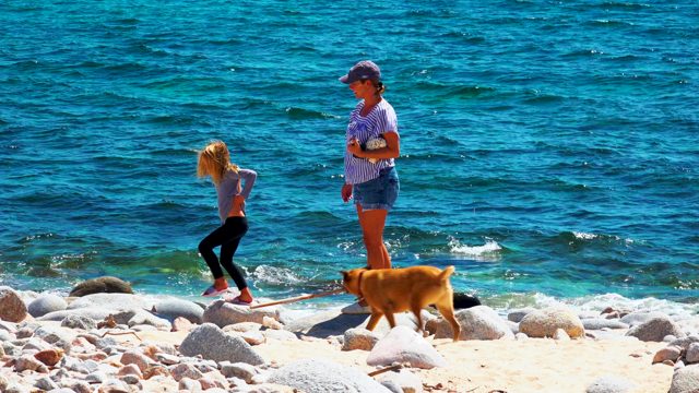 EL SARGENTO LA VENTANA MEXICO-2020: Child and Adult with Dog on Rocky Shore