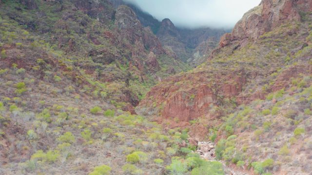 PUERTO ESCONDIDO BCS MEXICO-2020: Red Rock Canyon with Drifting Clouds over Peaks