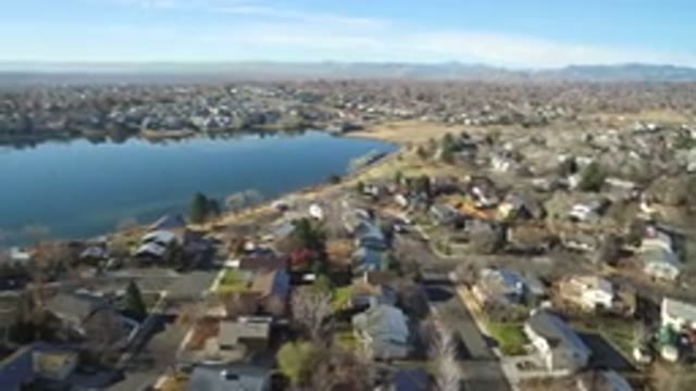 WESTMINSTER COLORADO-2016: Lake Between Small Houses With Trees and Sky