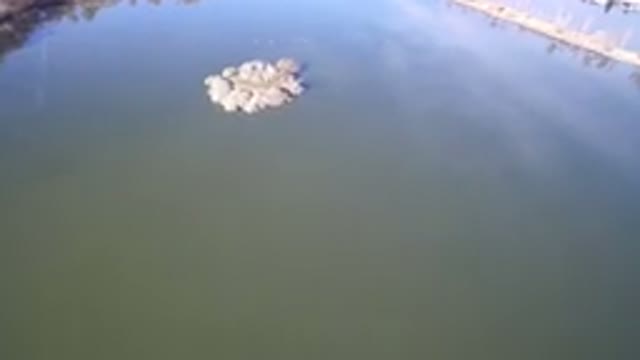 WESTMINSTER COLORADO-2016: Aerial Footage Of A Large Body Of Dark Still Water With Pile Of Stones