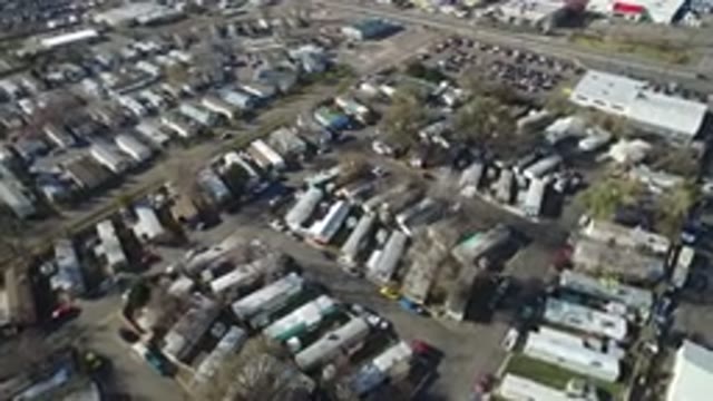 WESTMINSTER COLORADO-2016: A Field Filled With Buildings Trailers Cars And Trucks