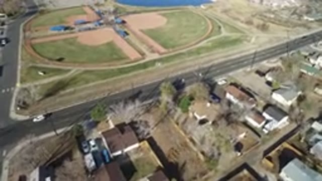 WESTMINSTER COLORADO-2016: Light Green Field With Swimming Pool Aside And A Busy Street