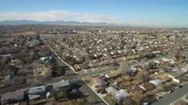 HIDDEN LAKE COLORADO-2016: Car Moving Towards Hill In Town With Way Junction