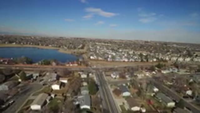 HIDDEN LAKE COLORADO-2016: View Of A Busy City With Cars Roaming Beside A Lake