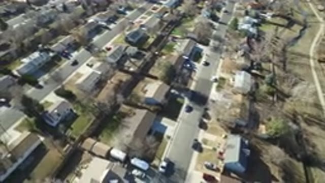 HIDDEN LAKE COLORADO-2016: Car Driving Down The Street In A Neighborhood Filled
