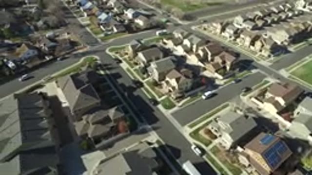 HIDDEN LAKE COLORADO-2016: Overhead Of Car Driving Down A Quiet Street Between