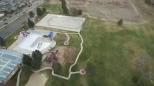 WESTMINSTER COLORADO-2016: Child Playing on Green Land Near Hockey Ground and Building