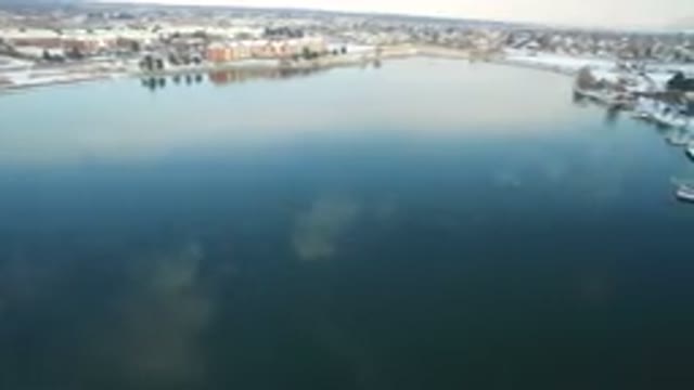 HIDDEN LAKE COLORADO-2016: Overhead Of Placid Lake In Winter With Clouds