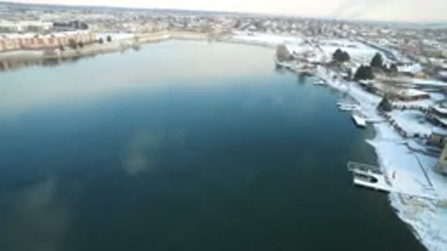 HIDDEN LAKE COLORADO-2016: Flying View Of A Bay Near The City With Snow In