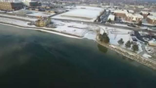 HIDDEN LAKE COLORADO-2016: Flying While Looking Below At Icy Lake And Snowy City