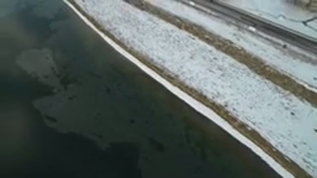 HIDDEN LAKE COLORADO-2016: Overhead View Of Cars Driving Past Frozen Lake In