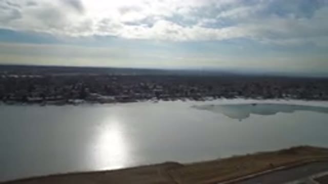 HIDDEN LAKE COLORADO-2016: Drone Footage Over Partially Frozen Lake And Shore