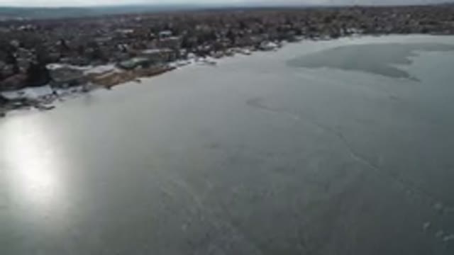 HIDDEN LAKE COLORADO-2016: Overhead View Of Ice-Covered Lake With Sun Reflecting Off