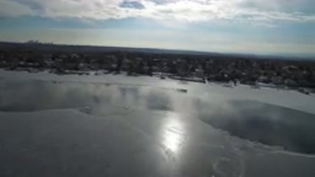 HIDDEN LAKE COLORADO-2016: A Partially Frozen River Lined With Evergreen Trees