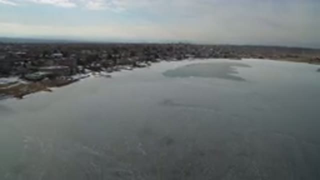 HIDDEN LAKE COLORADO-2016: Aerial View Moving Along A Frozen River Running