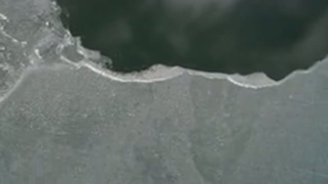 HIDDEN LAKE COLORADO-2016: Top View Of A Sea Of Green Water With A Frozen Part
