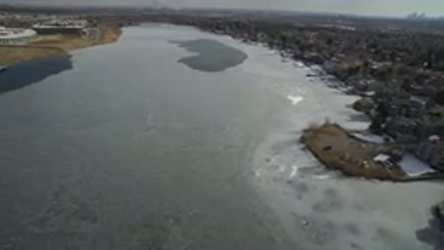 HIDDEN LAKE COLORADO-2016: Large Frozen Lake Next To A Large City Covered In Snow