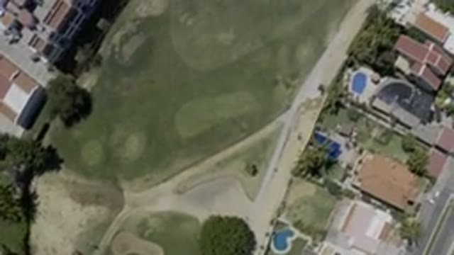 LOS CABOS MEXICO-2019: Drone Footage Over Town Buildings Grassy Area Pools Roads