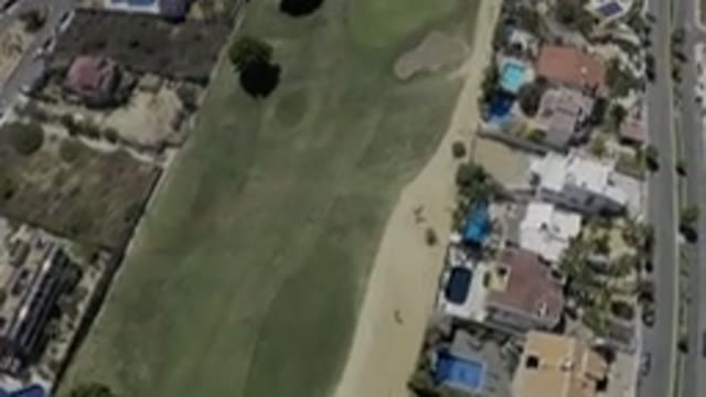 LOS CABOS MEXICO-2019: An Open Grass Field Between Houses In Parallel A View Of
