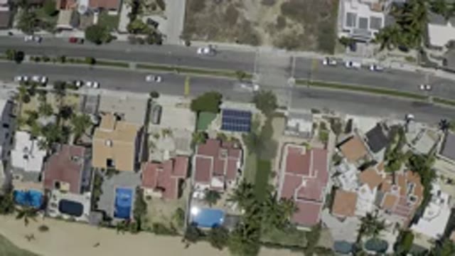 LOS CABOS MEXICO-2019: Multiple Cars Driving On A Two Lane Road In A Small Town