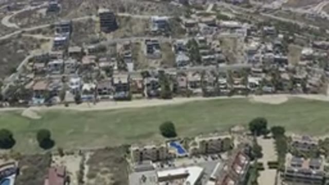 LOS CABOS MEXICO-2019: Green Pastures With Small Buildings And Trees Planted All