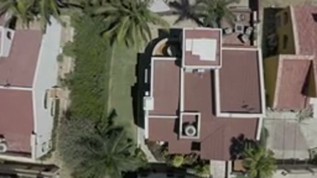 LOS CABOS MEXICO-2019: Drone Footage Descending On Red Tile Roof Building In Suburban Neighborhood