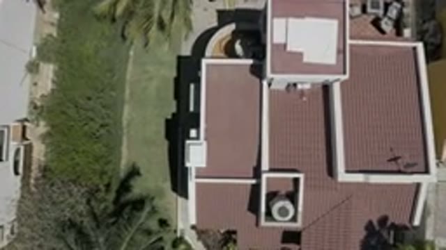 LOS CABOS MEXICO-2019: A White Building With A Red Roof And Antenna
