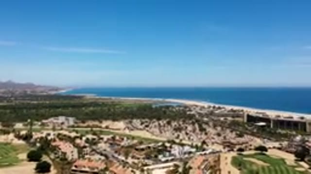 LOS CABOS MEXICO-2019: Flying Over Buildings Homes Roads And Fields Towards The
