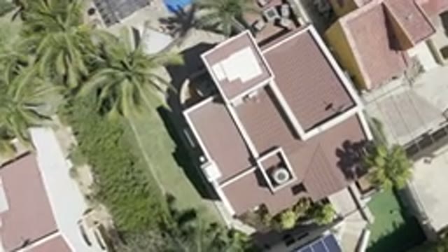 LOS CABOS MEXICO-2019: Drone Getting Closer To Landing On Ground Near Building
