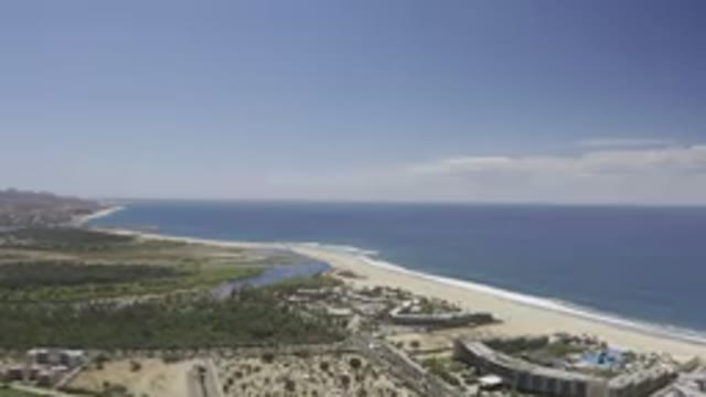LOS CABOS MEXICO-2019: The Long Curving Shoreline Beside the Beautiful Blue Sea