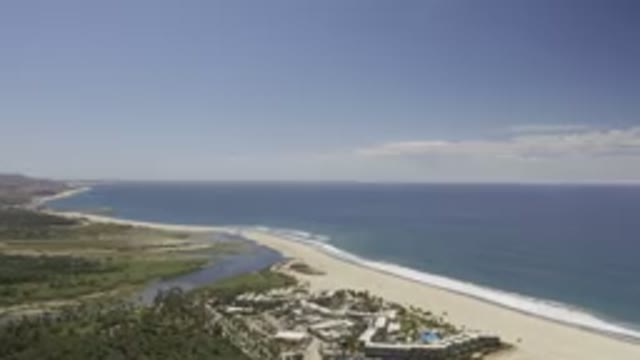 LOS CABOS MEXICO-2019: Top View Drone Shot of Blue Ocean, Hotel, Trees and Sky
