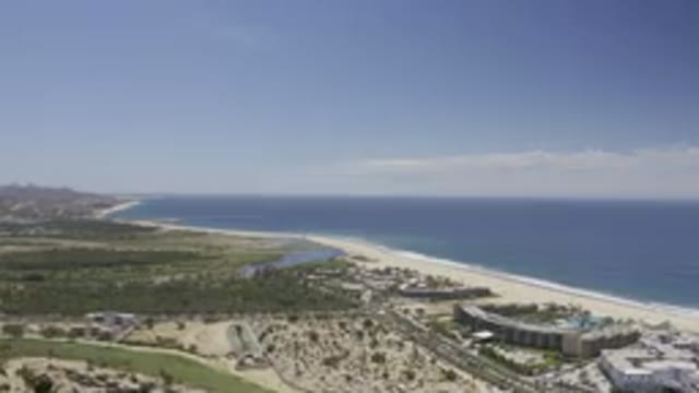 LOS CABOS MEXICO-2019: A Blue Sky With White Clouds, Sand And Green Pastures