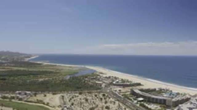 LOS CABOS MEXICO-2019: White Sand Beach And Ocean Along Multi-Story Buildings