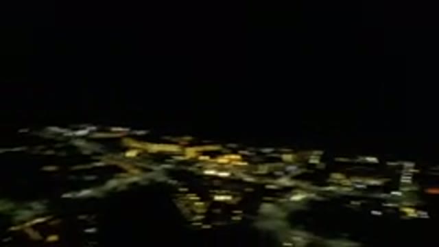LOS CABOS MEXICO-2019: Camera Pans Quickly Over City Lit Up Yellow At Night