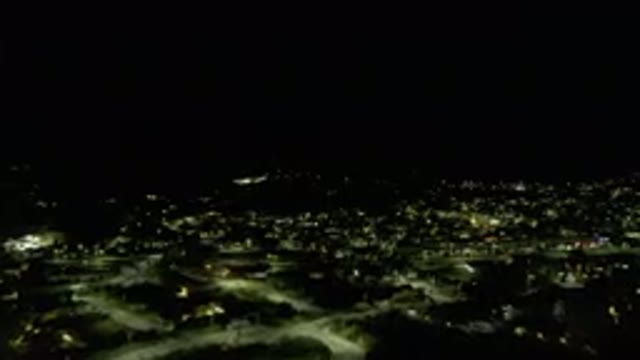 LOS CABOS MEXICO-2019: Drone Footage Over City At Night Buildings Lit Traffic