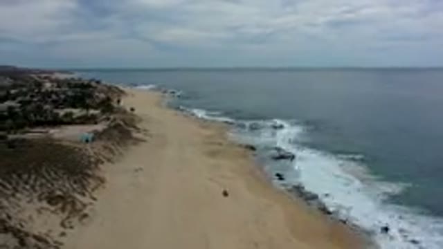 LOS CABOS MEXICO-2019: Fast Forward Beach Waves Lapping Onto The Sand Along The