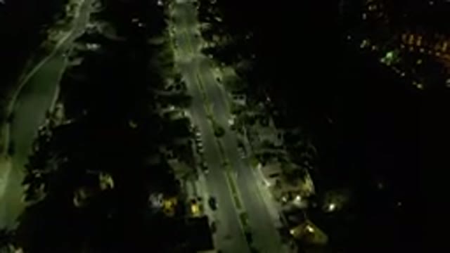 LOS CABOS MEXICO-2019: Aerial View Of Dark Road Lined With Trees Houses And