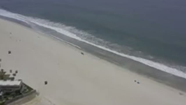 LOS CABOS MEXICO-2019: Overhead View Of Waves Crashing Onto An Empty Sandy Beach