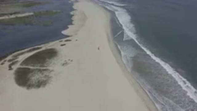 LOS CABOS MEXICO-2019: Overhead Shot Of Waves Breaking On A Long Sand Beach
