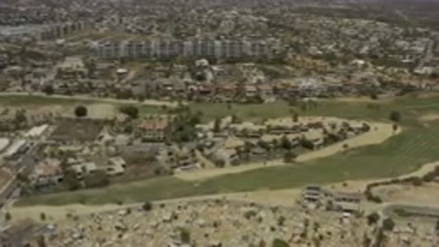 LOS CABOS MEXICO-2019: Aerial Footage Of A Big City With Patches Of Green Grass