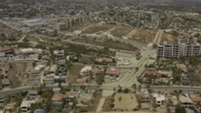 LOS CABOS MEXICO-2019: Drone Footage Over City Buildings Roads Pools Desert Landscape