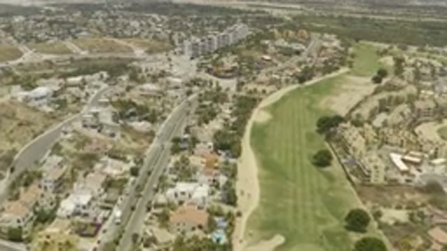 LOS CABOS MEXICO-2019: Drone Video Of Large City Buildings With Large Green Fields