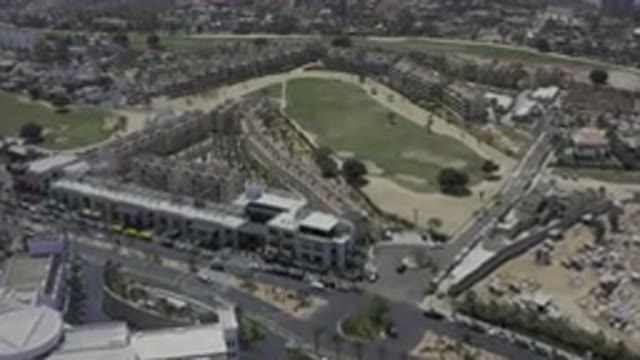 LOS CABOS MEXICO-2019: Green Golf Field Surrounded By Walls Of Buildings And